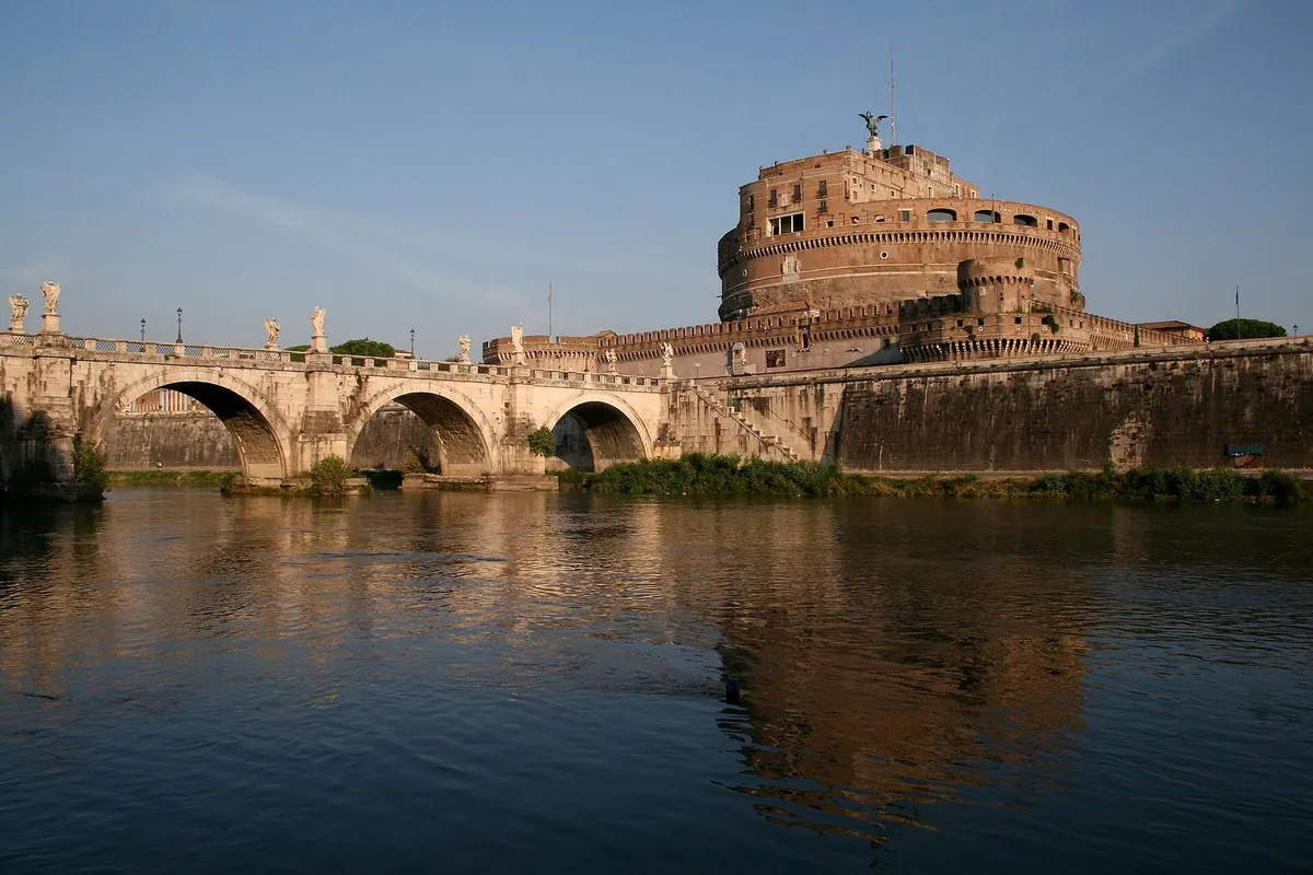 Castel Sant'Angelo and Ponte Sant'Angelo reflected in the Tiber at sunset