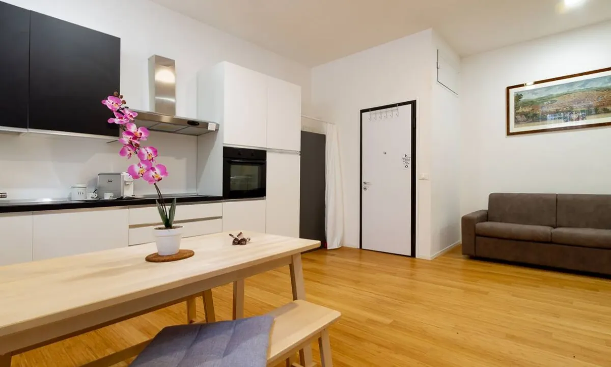Kitchen, laid table and sofa