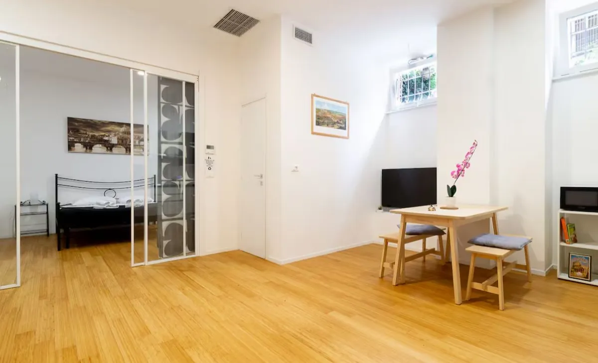 Open-plan space: the bedroom behind the glass partition and the dining area
