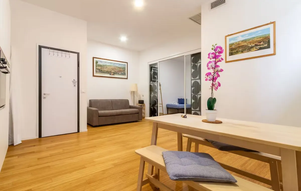 Living area with a wooden table, benches and sofa
